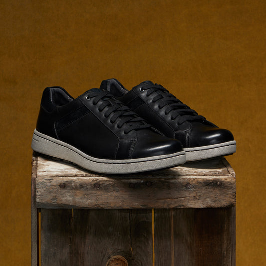 Men's slip-on sneakers in soft black leathers with a casual outsole.